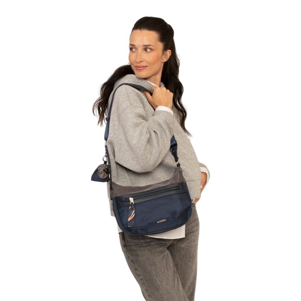 Modelo llevando el bolso cruzado, destacando su tamaño compacto y diseño ergonómico para el día a día.